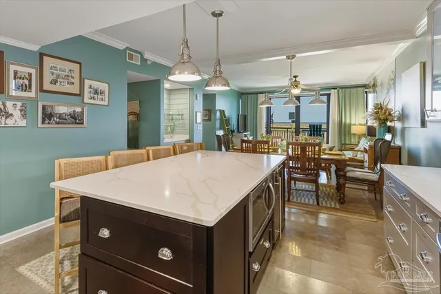 a kitchen with a table chairs and a chandelier