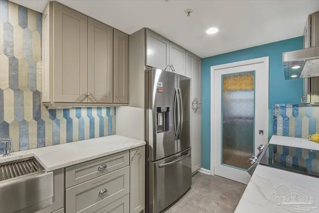 a kitchen with stainless steel appliances granite countertop a refrigerator and a sink