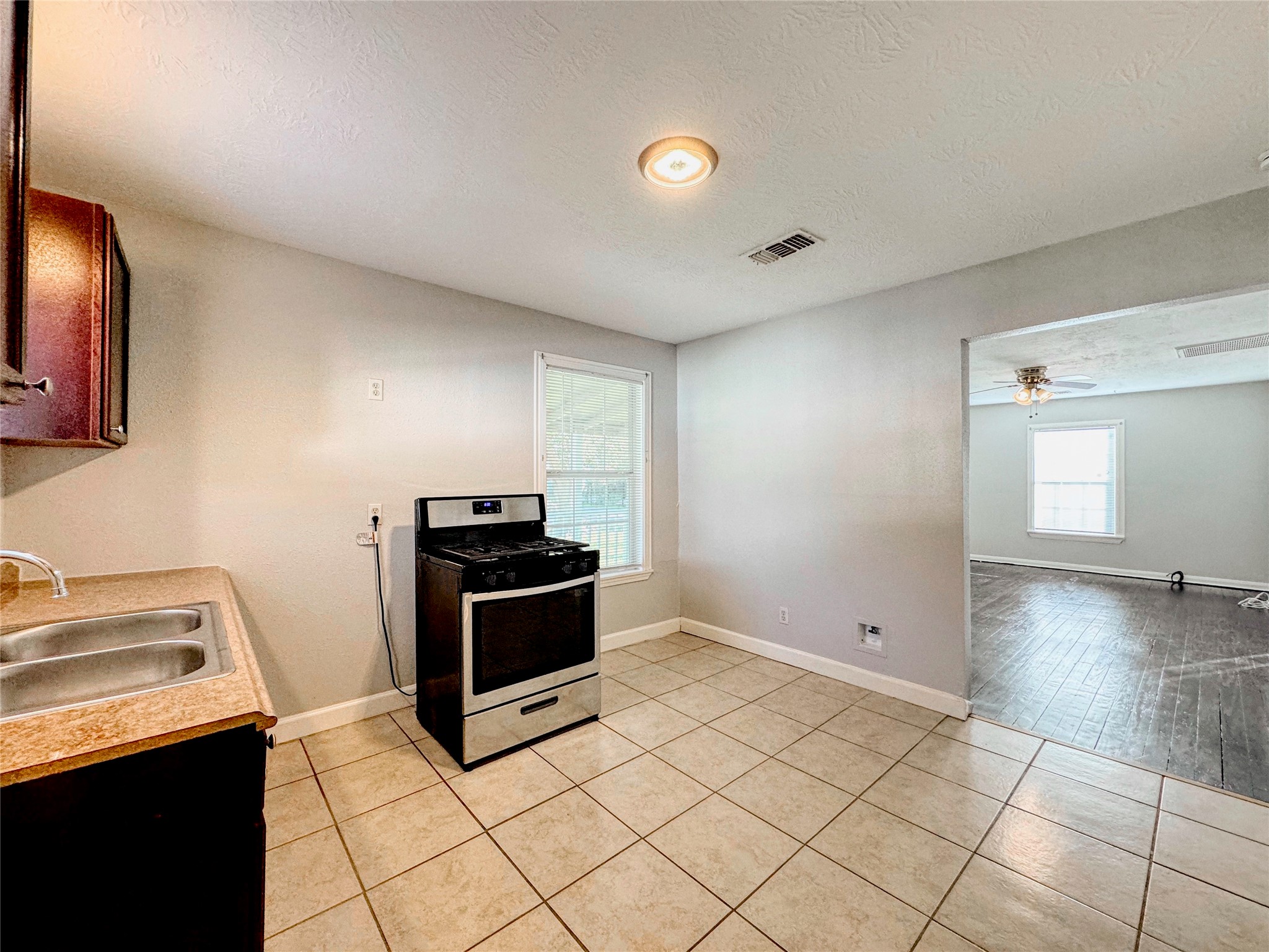 6714 Dillon Street Houston, TX 77061 - Photo 8 of 20 a kitchen with granite countertop a stove and a sink