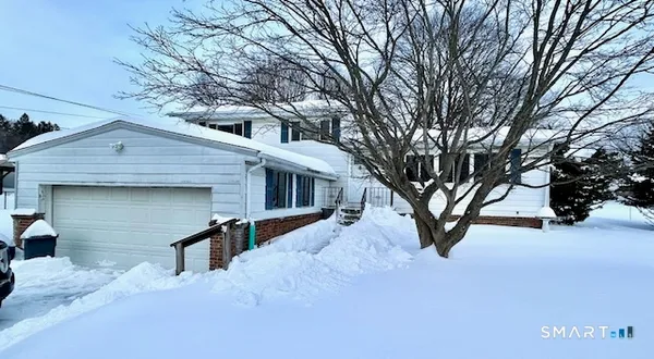 a view of a house with a snow in the yard