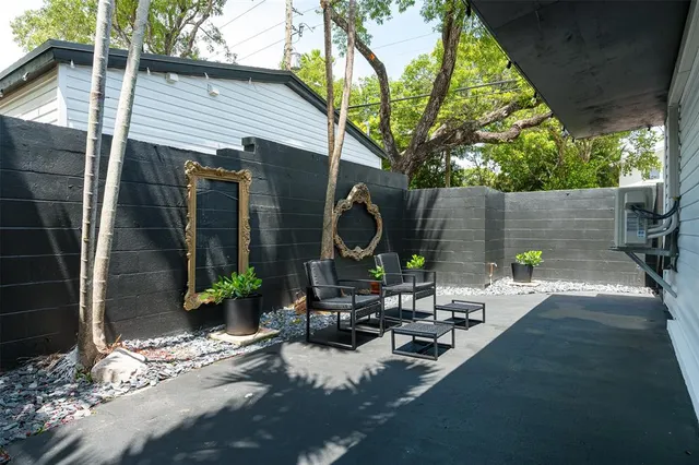 a view of a chairs and table in backyard of the house
