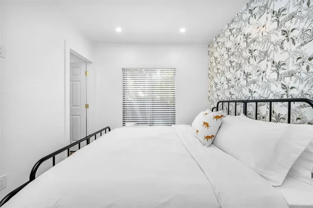 a bedroom with a bed and a window