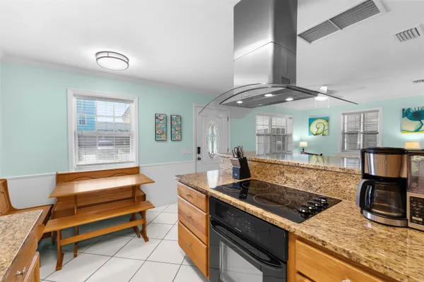 a living room with furniture a flat screen tv and kitchen view