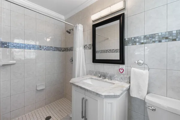 a kitchen with stainless steel appliances granite countertop a refrigerator a stove a microwave and a dining table