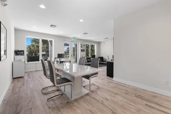 a living room with furniture and kitchen view