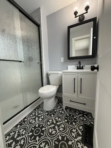 a bathroom with a sink toilet and shower