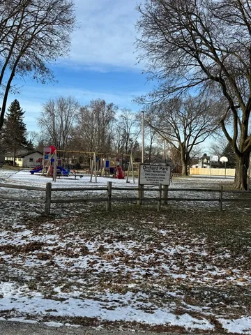 a view of a yard with a house in the background