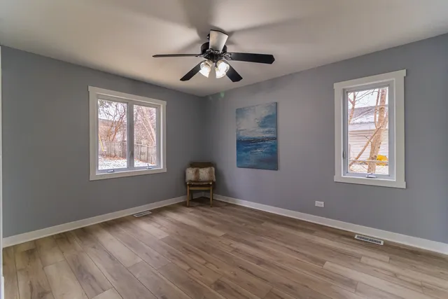 a view of wooden floor and windows in a room