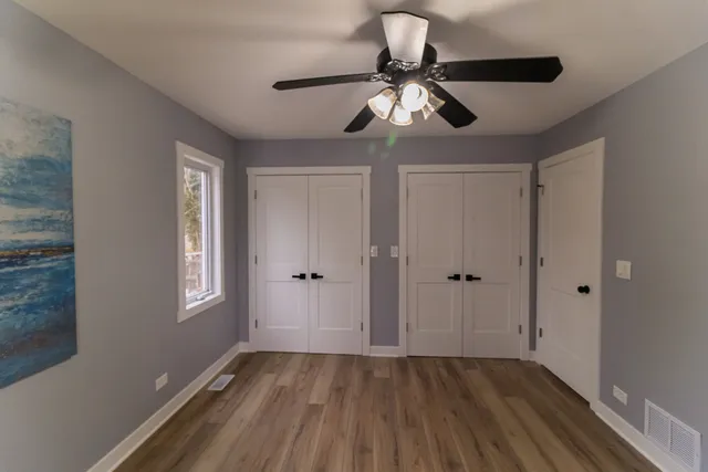 a view of room with hardwood floor and ceiling fan