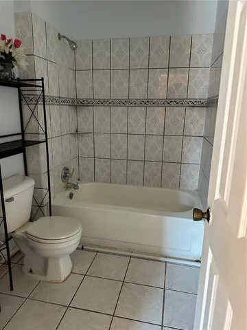 a bathroom with a bathtub and toilet