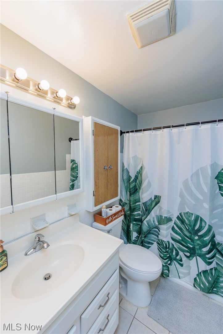4260 Ridgeview Road Cleveland, OH 44144 - Photo 23 of 34 Bathroom featuring vanity with extensive cabinet space, toilet, and tile floors