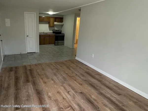 a view of kitchen with sink and refrigerator