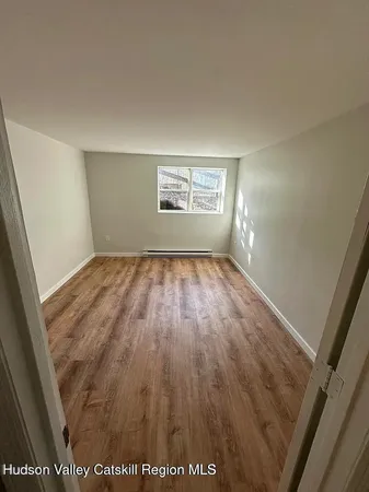 an empty room with wooden floor