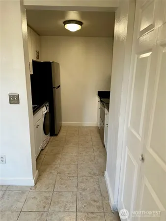 a kitchen with a refrigerator and a sink