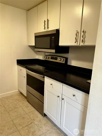 a utility room with cabinets washer and dryer