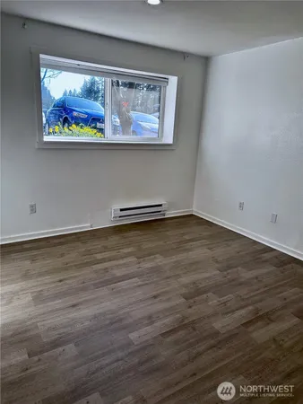 a view of a room with wooden floor