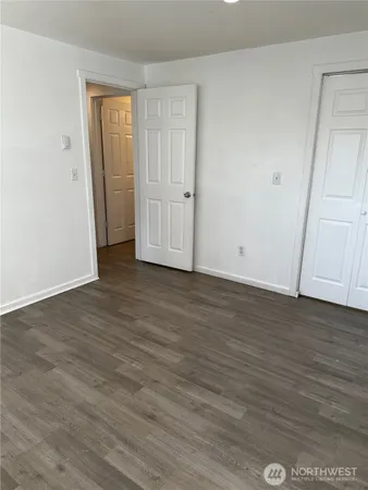 a view of room with window and wooden floor