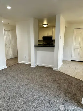 a view of kitchen with a sink oven and cabinets