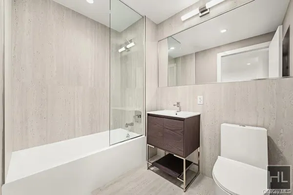 a bathroom with a bathtub shower sink and toilet