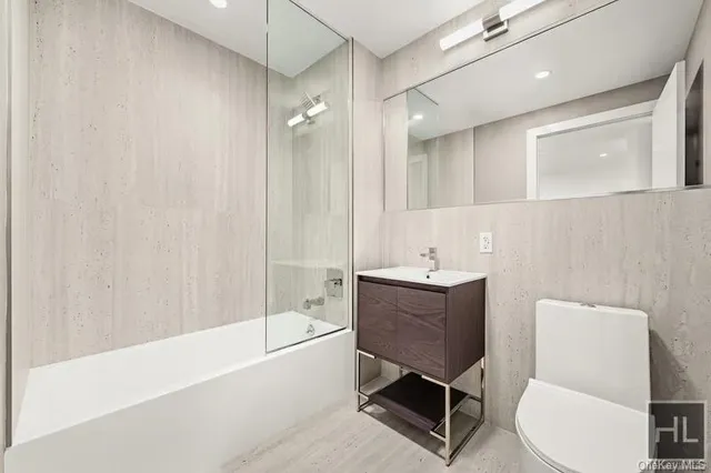 a bathroom with a bathtub shower sink and toilet