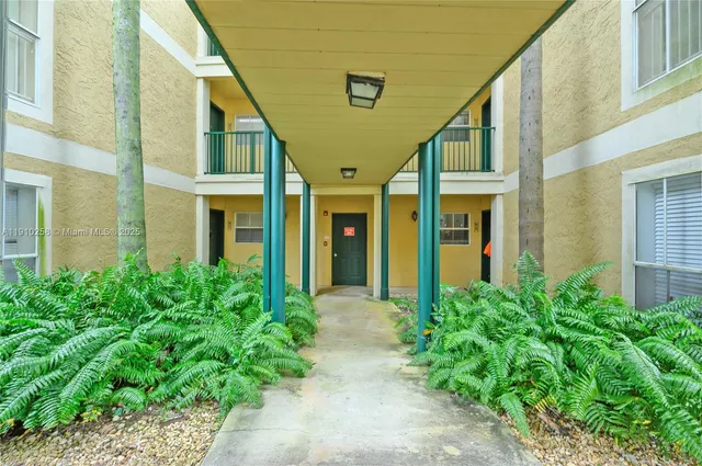 a view of an entryway of the house with potted plants