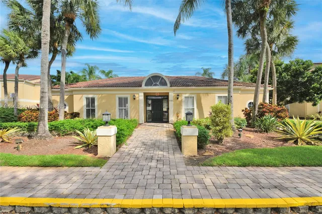 a front view of a house with garden and porch