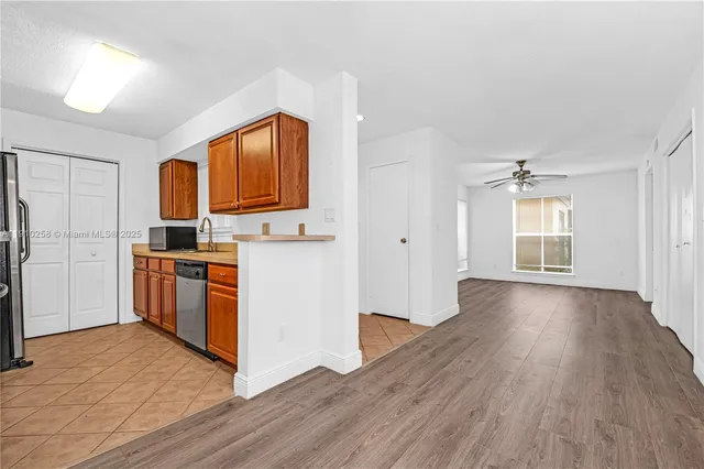 a view of kitchen with sink and wooden floor