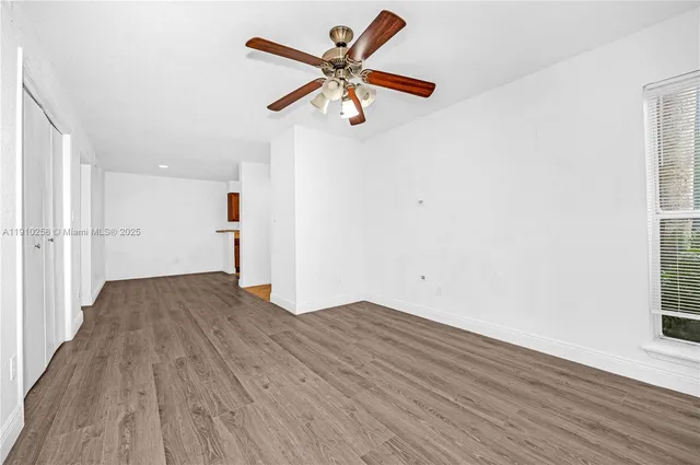 a view of empty room with wooden floor