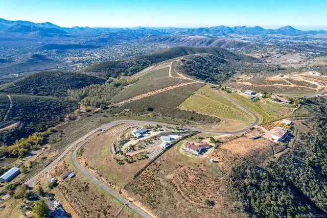 a view of a dry yard with mountains in the background