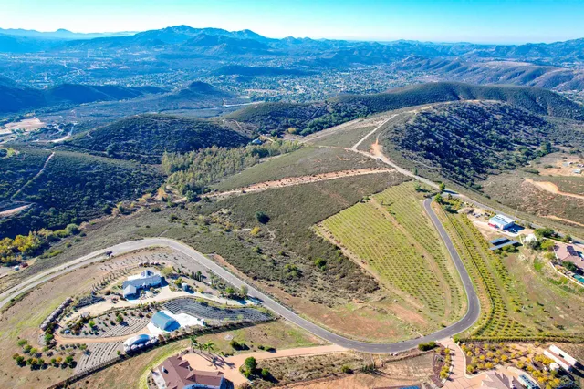 a view of a mountain with a field