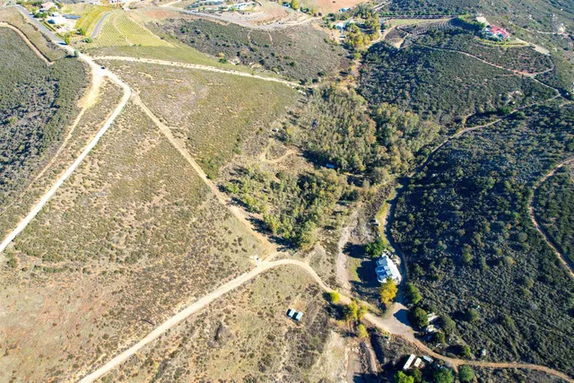 a view of a backyard with wooden fence