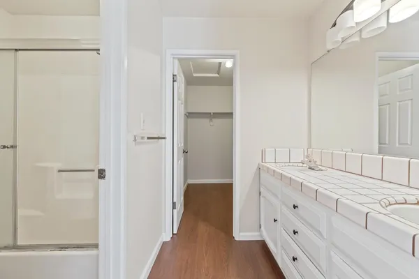 a bathroom with a granite countertop sink and a mirror
