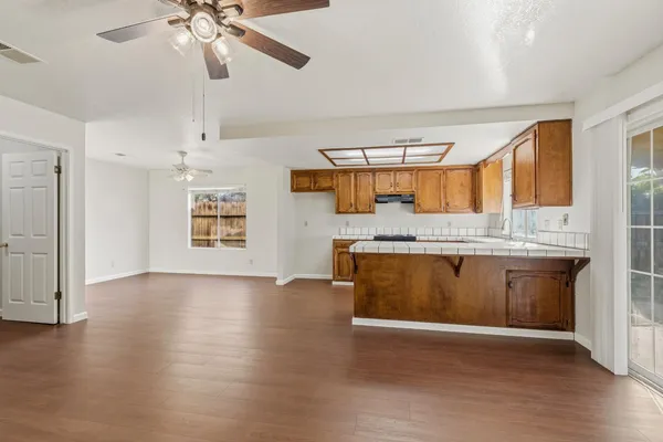 a view of a kitchen with a sink cabinets and wooden floor