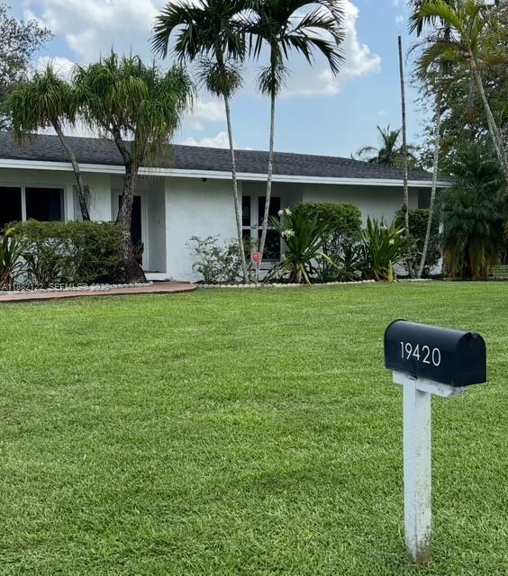 19420 Southwest 307th Street Homestead, FL 33030 - Photo 2 of 17 a front view of a house with garden