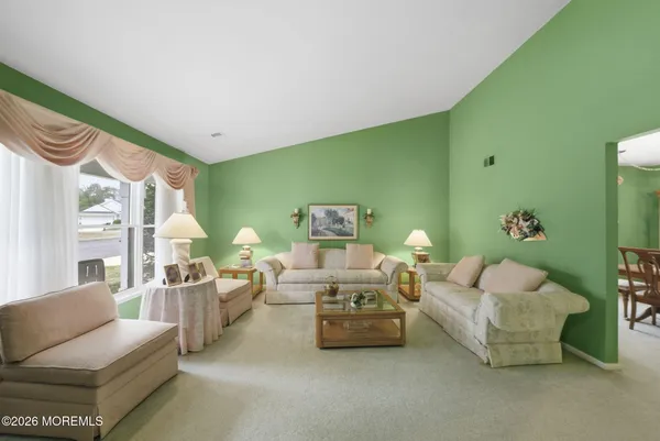 a dining room with furniture potted plants and a chandelier