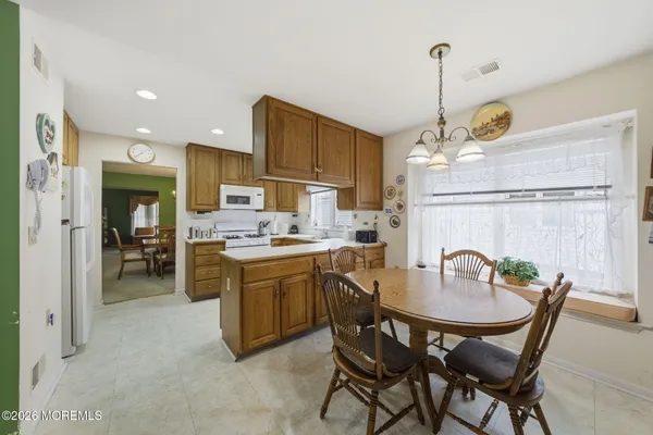 a kitchen with a stove a sink and a refrigerator