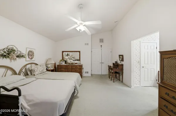 a spacious bathroom with a granite countertop sink mirror and a