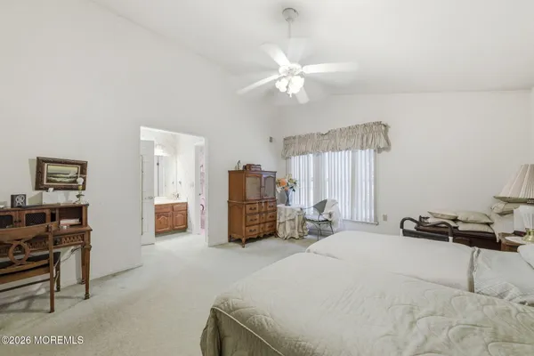a bedroom with a bed chair and window