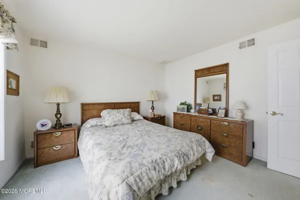 a view of walk in closet with clothes
