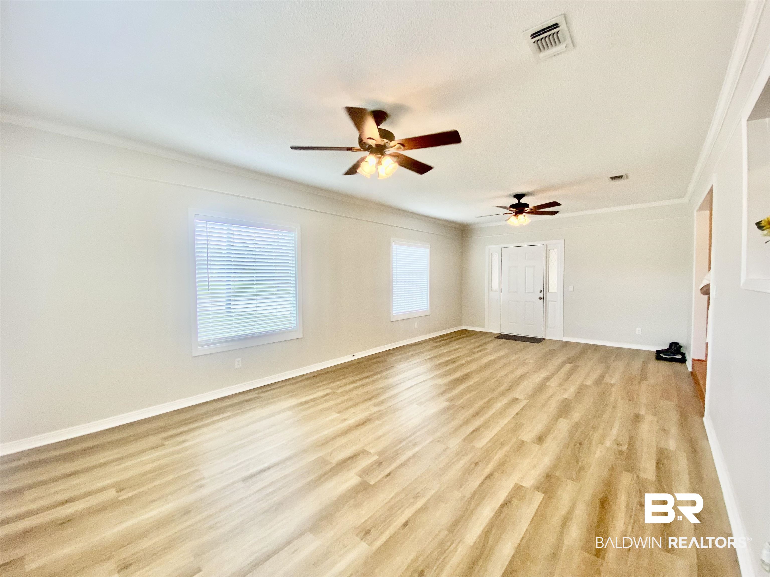 265 Azalea Drive Monroeville, AL 36460 - Photo 17 of 39 Spare room with ceiling fan, light wood-type flooring, and ornamental molding