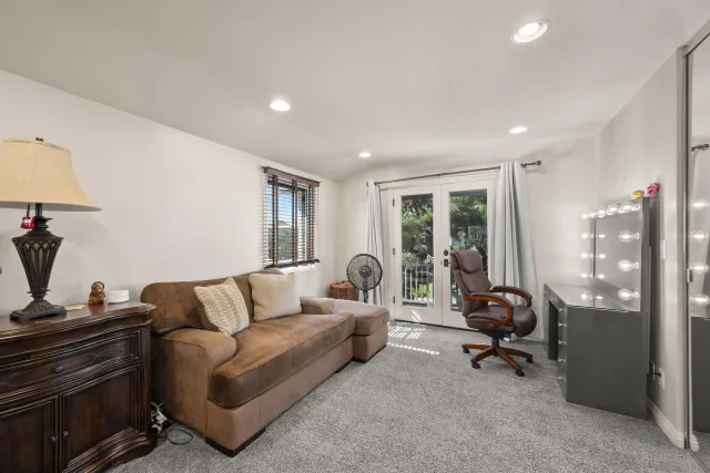a large bedroom with bed and furniture