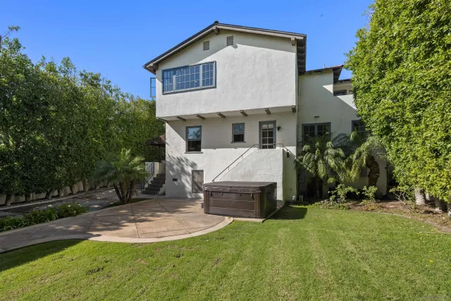 a view of a house with a yard and tree