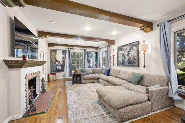 a living room with furniture a flat screen tv and a fireplace