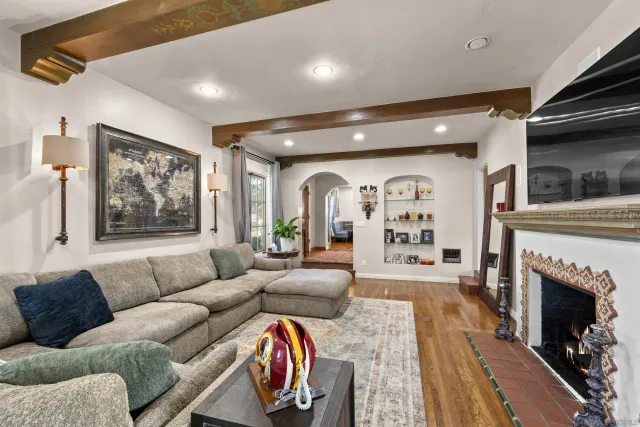 a living room with furniture fireplace and window