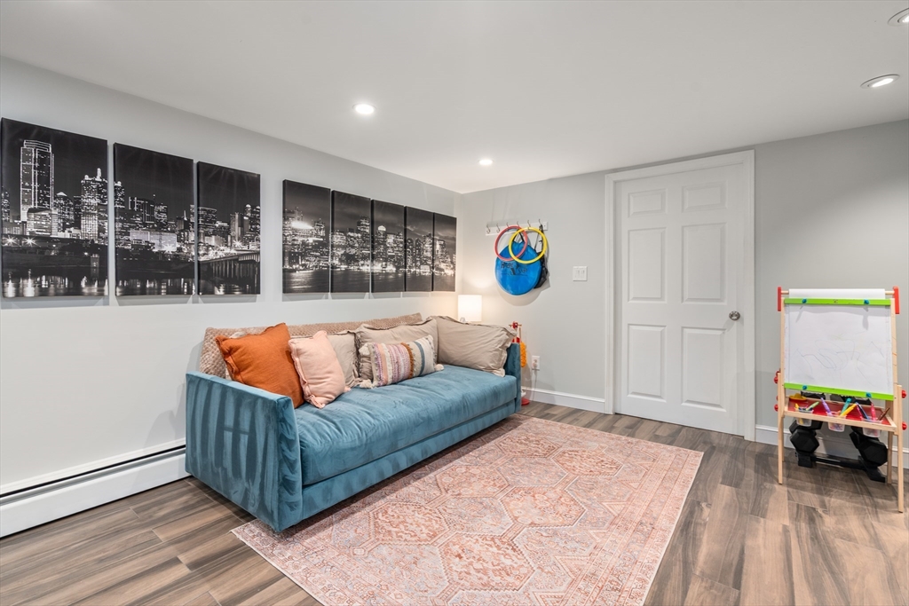 57 Marlboro Road Sudbury, MA 01776 - Photo 23 of 40 a living room with furniture and a flat screen tv