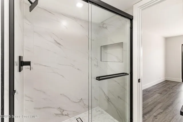 a bathroom with a glass shower door