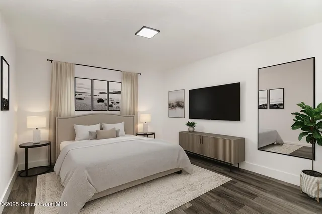 a bedroom with a bed and a flat screen tv