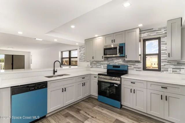 a kitchen with a sink stove and microwave