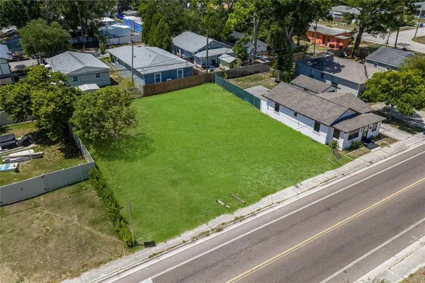an aerial view of a house with garden space and street view