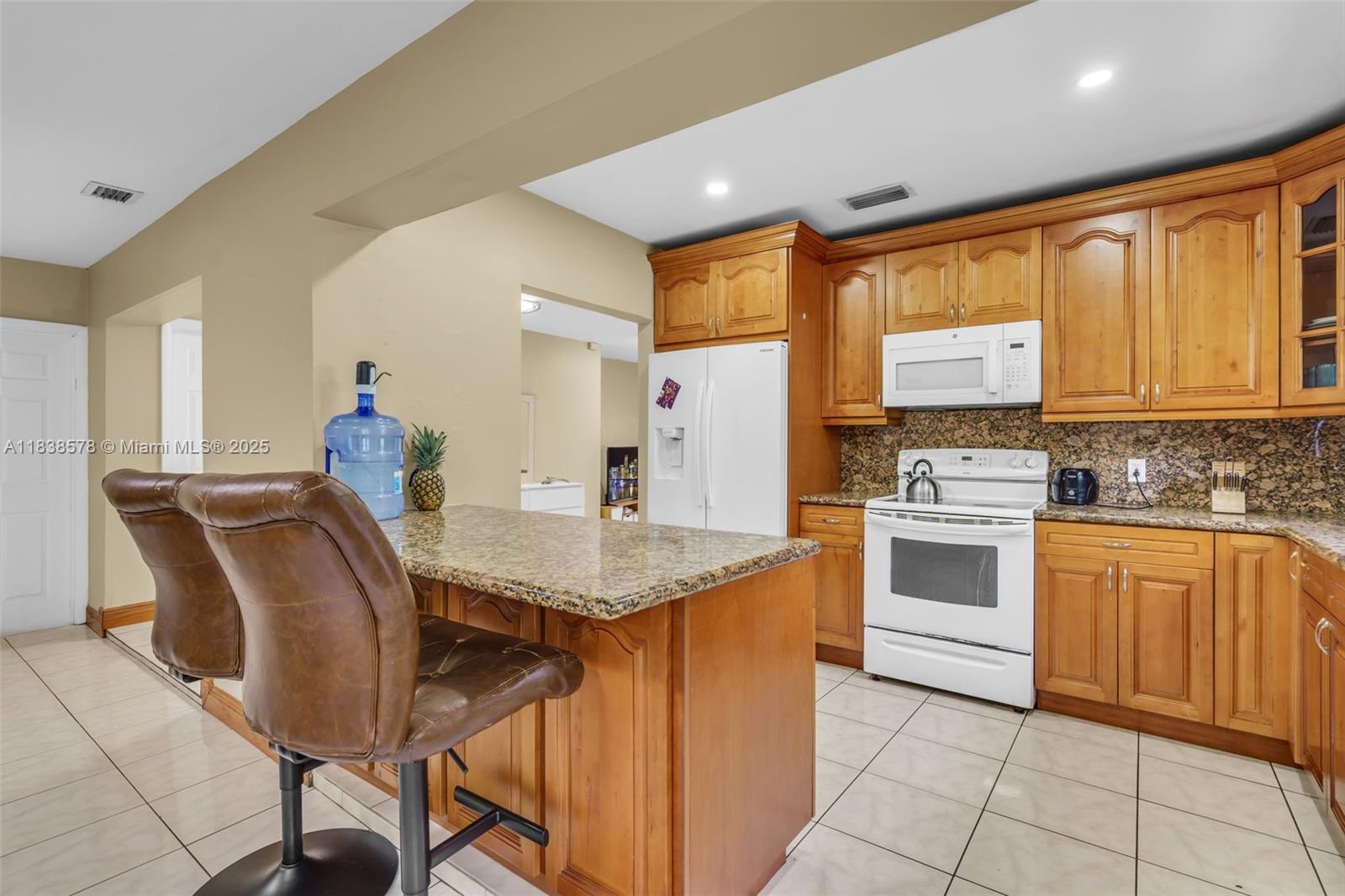 2761 Southwest 33rd Court Miami, FL 33133 - Photo 11 of 46 a kitchen with stainless steel appliances granite countertop a stove a sink dishwasher and a refrigerator